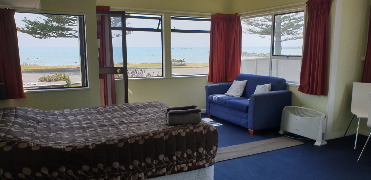 This is a downstairs unit with a magnificent sea view. Bedding in this unit is a queen bed in the same studio space as the living and cooking areas and 2 single beds in a separate bedroom.
