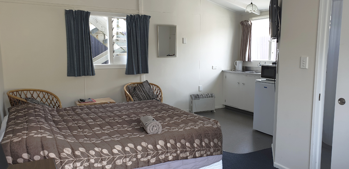 This is a downstairs unit that does not have a sea view. Bedding in this unit is a queen bed in the same studio space as the living and cooking areas.